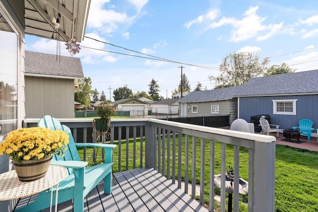 view of wooden balcony with a deck and a fire pit