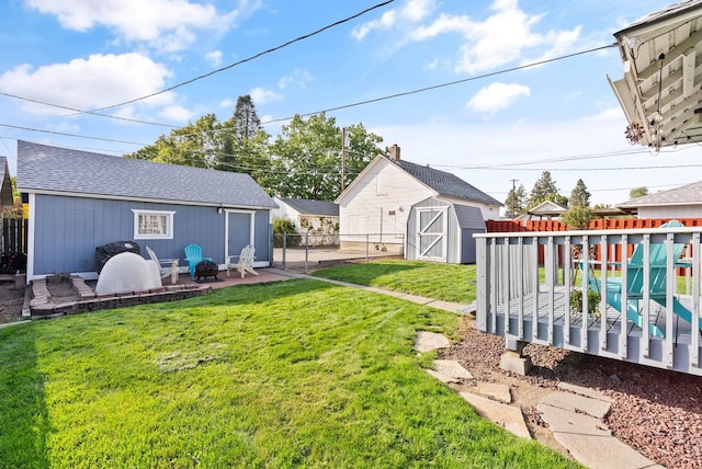 view of yard with a patio, an outbuilding, and a fenced backyard