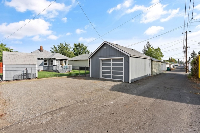 detached garage with driveway and fence