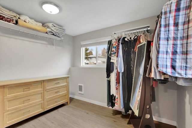 walk in closet featuring visible vents and light wood finished floors