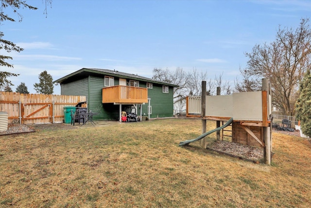 back of property with a lawn and a fenced backyard