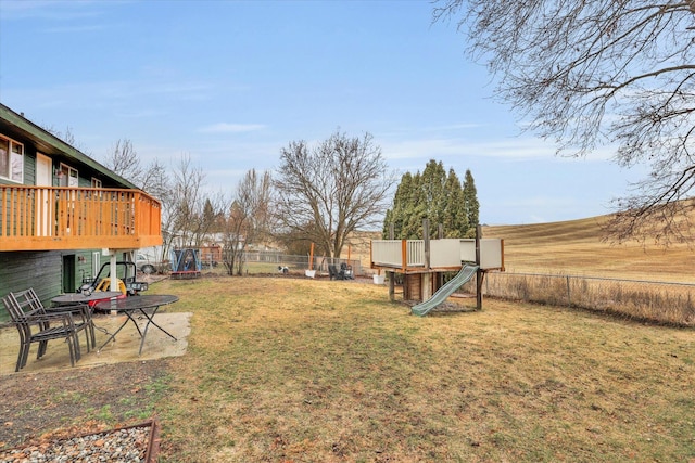 view of yard with a playground and fence