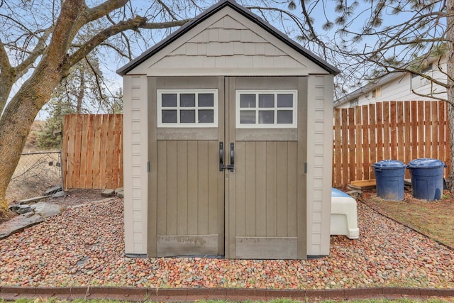 view of shed with fence