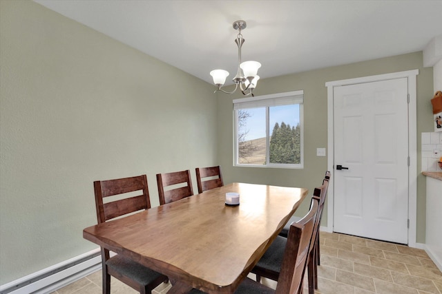 dining space with baseboards, baseboard heating, and a chandelier