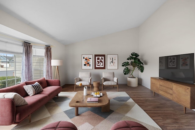 living room featuring wood finished floors and vaulted ceiling