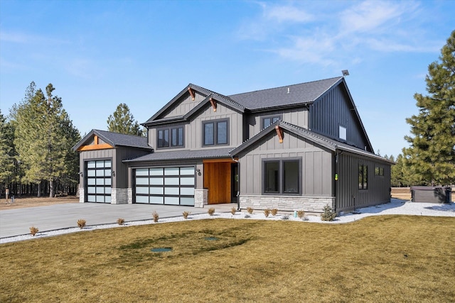 modern farmhouse featuring stone siding, a front lawn, board and batten siding, and driveway