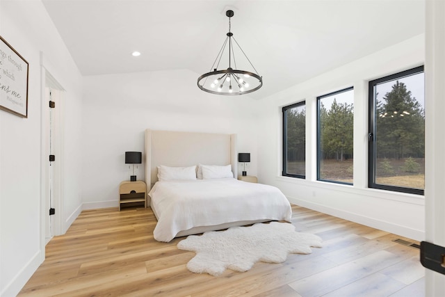 bedroom with light wood-style flooring, recessed lighting, baseboards, a chandelier, and vaulted ceiling