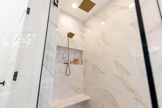 bathroom with a marble finish shower