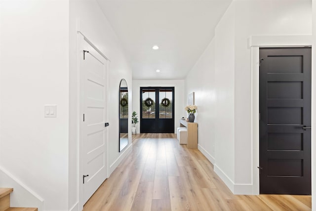 hall featuring light wood finished floors, stairway, recessed lighting, and baseboards