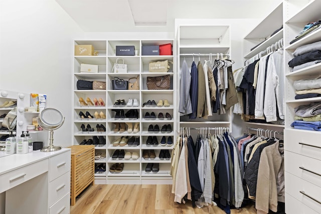 walk in closet featuring attic access and light wood-style flooring