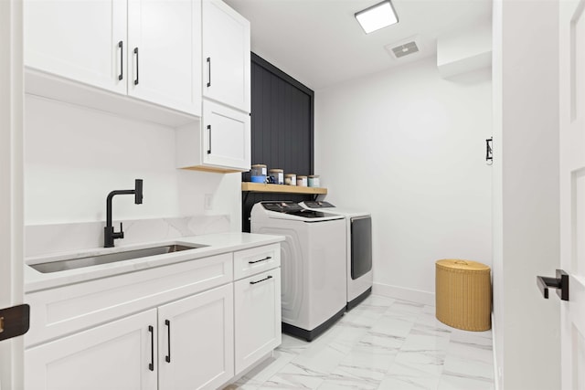 washroom featuring visible vents, marble finish floor, cabinet space, independent washer and dryer, and a sink