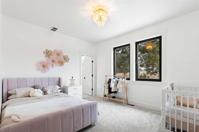 bedroom with visible vents, light carpet, and baseboards