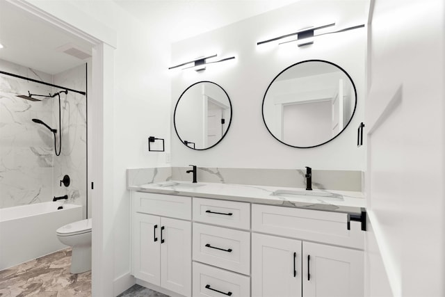 bathroom featuring double vanity, visible vents, toilet, and a sink