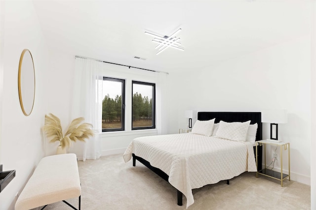 bedroom featuring baseboards, visible vents, and light carpet