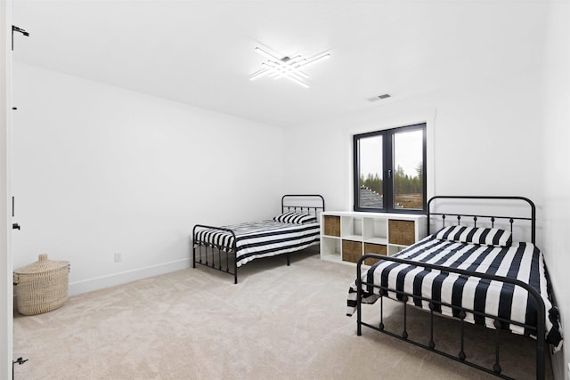 carpeted bedroom featuring visible vents and baseboards