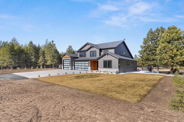 modern farmhouse style home with concrete driveway and a front lawn