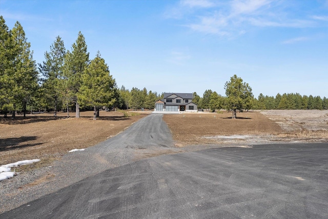 view of road featuring aphalt driveway and a rural view