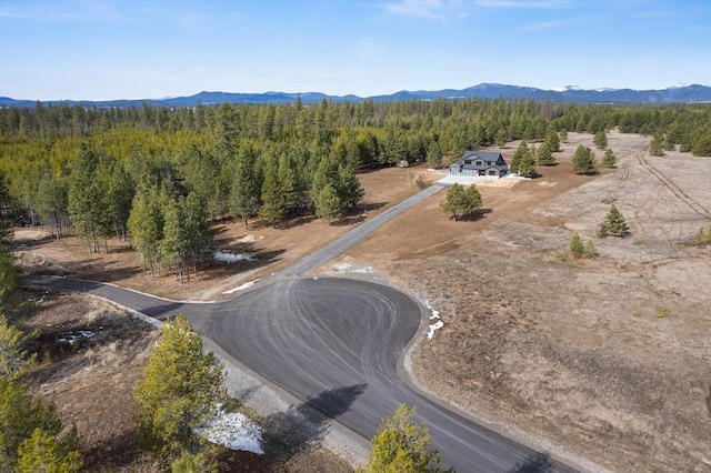 aerial view with a wooded view and a mountain view