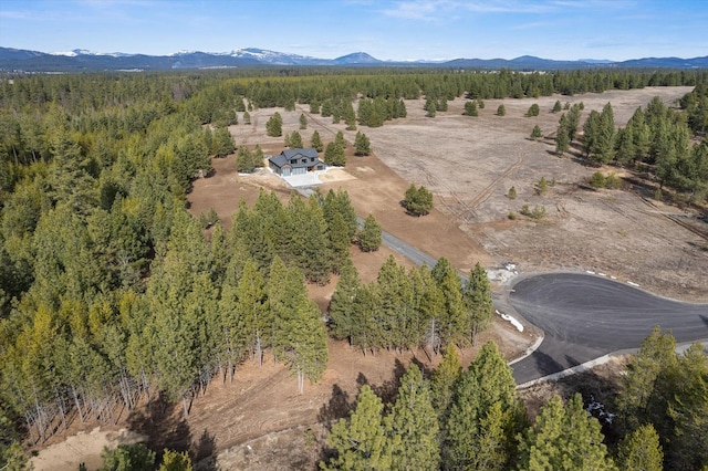 aerial view featuring a forest view and a mountain view