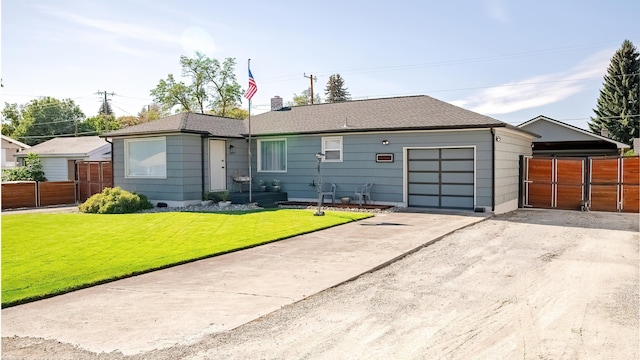 rear view of property with a gate, fence, a yard, concrete driveway, and a garage