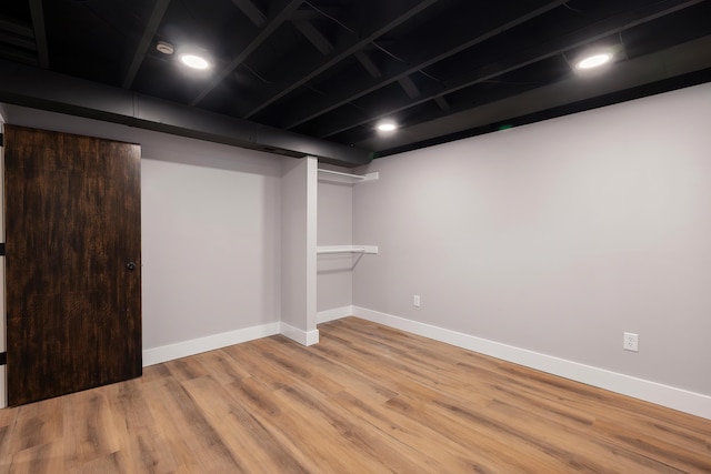 finished basement with baseboards and wood finished floors