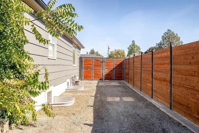 view of yard with fence and a gate