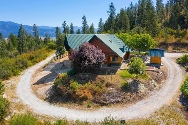 drone / aerial view featuring a mountain view and a wooded view