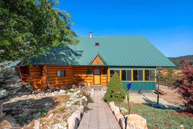 log cabin featuring metal roof, log exterior, and a standing seam roof