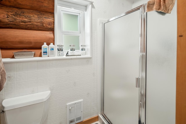 full bath featuring visible vents, a stall shower, toilet, and tile walls