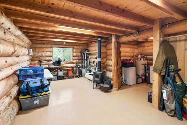 basement with water heater and a wood stove