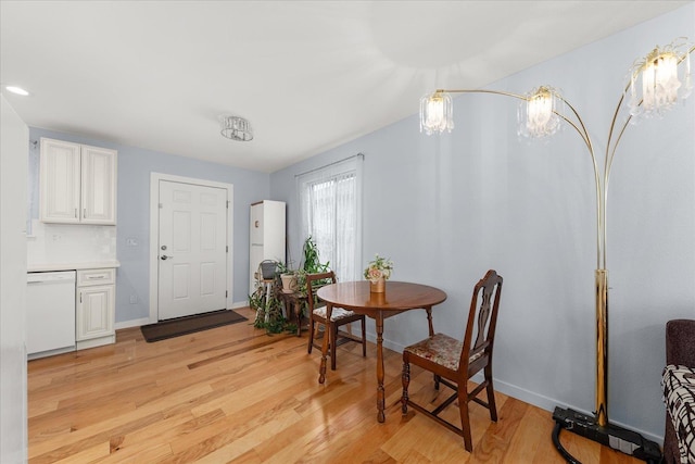 dining room with light wood-type flooring and baseboards