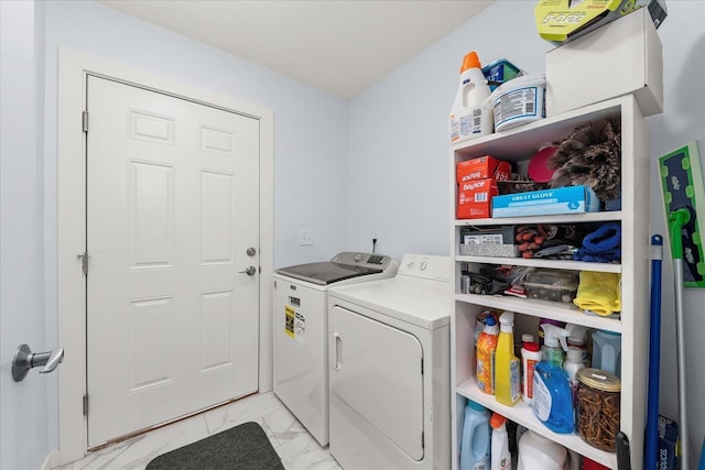 laundry area featuring marble finish floor, washing machine and dryer, and laundry area