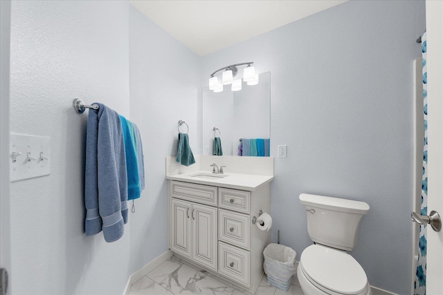 bathroom featuring baseboards, marble finish floor, vanity, and toilet