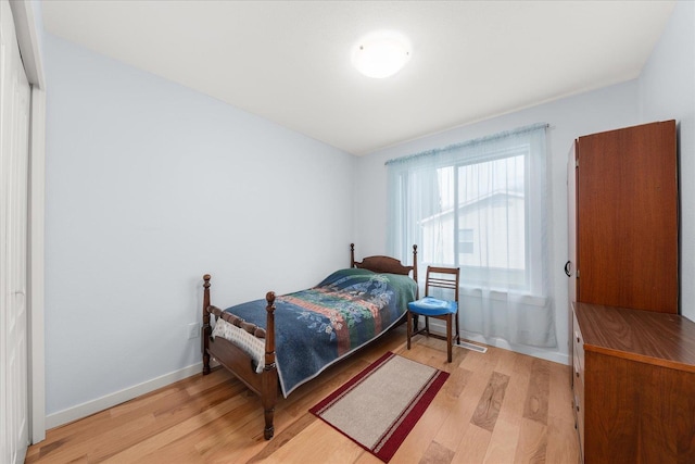 bedroom featuring baseboards and light wood-style flooring