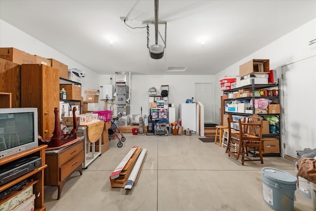 garage with white refrigerator and a garage door opener