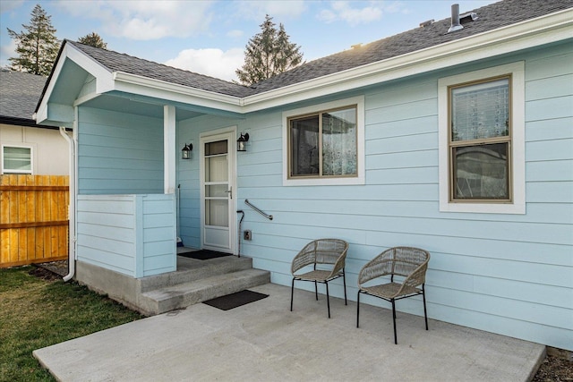 entrance to property with a patio area and fence