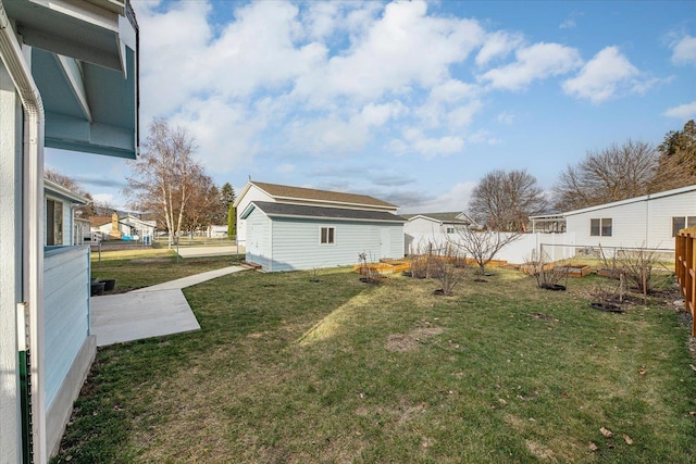 view of yard featuring an outbuilding and fence