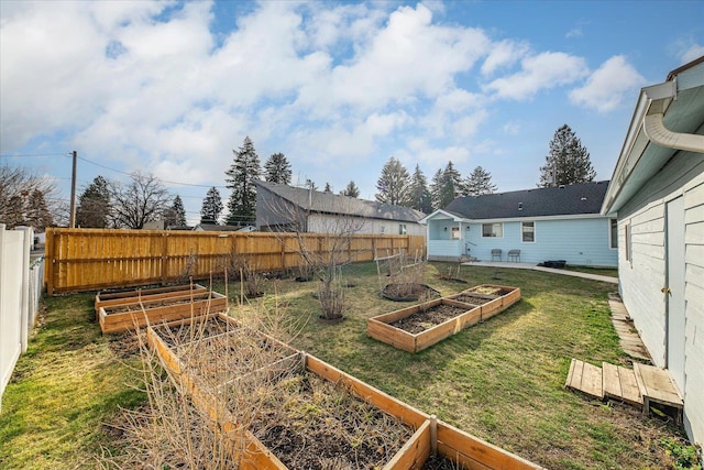 view of yard with a garden and fence