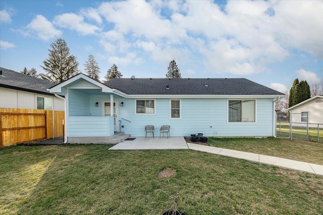 back of property with a fenced backyard, a patio area, a yard, and a gate