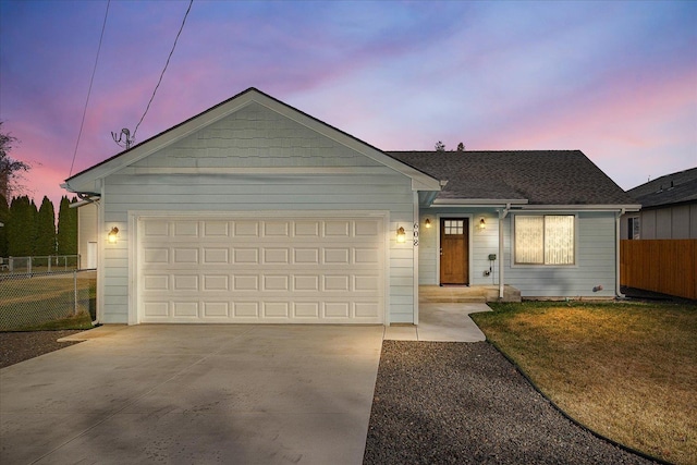 ranch-style home with concrete driveway, fence, and a garage