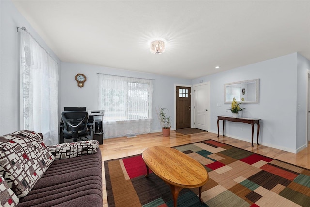 living room featuring recessed lighting, baseboards, and wood finished floors