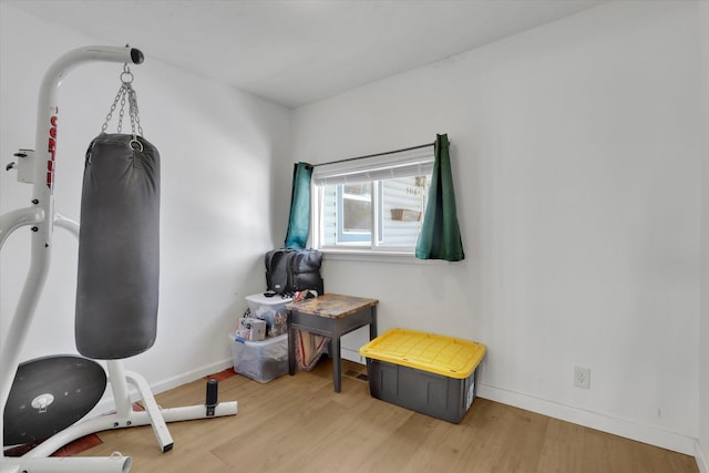 miscellaneous room featuring baseboards and wood finished floors