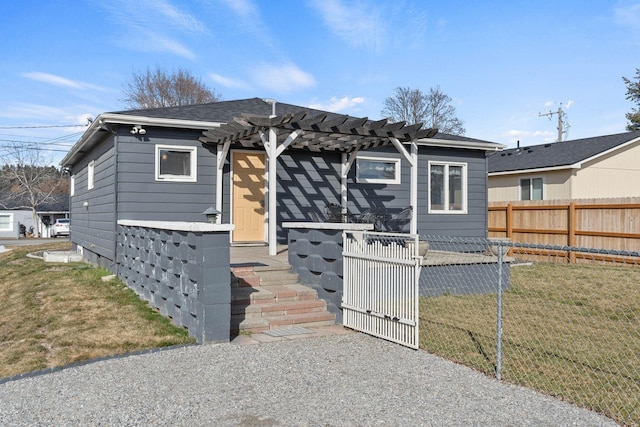 view of front of home with a gate, a front lawn, a pergola, and fence