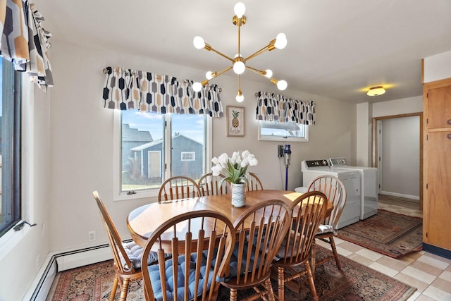 dining area featuring baseboard heating, washing machine and dryer, and an inviting chandelier