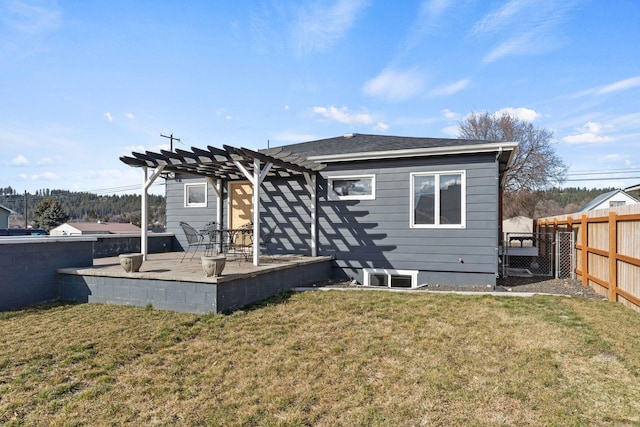 rear view of house with a yard, a patio area, a pergola, and fence