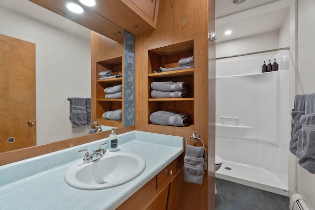 bathroom featuring a stall shower, vanity, and a baseboard heating unit