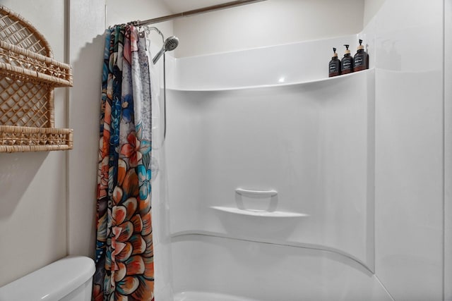 bathroom with toilet and a shower with curtain