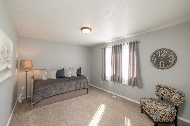 carpeted bedroom with visible vents and baseboards