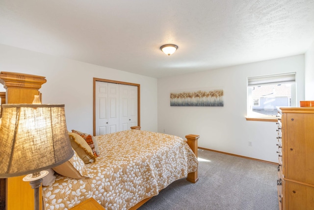 bedroom with carpet flooring, baseboards, a closet, and a textured ceiling