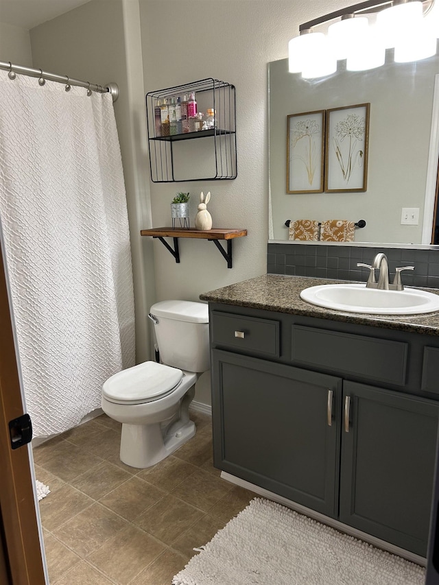 bathroom featuring vanity, curtained shower, and toilet